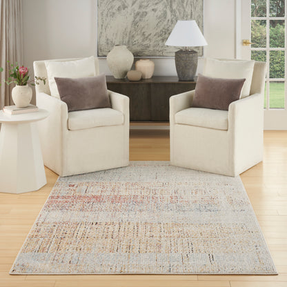Two cream fabric armchairs with brown pillows flank a dark wood console; pale multicolor rug ties the bright living room.