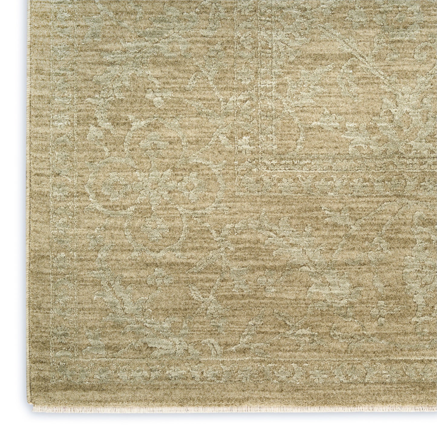 Rectangular beige distressed area rug with subtle cream floral motif & decorative border; light fringe along edge.