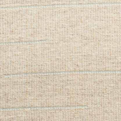 Beige woven jute rug close-up with natural fiber texture and stitched panel lines.