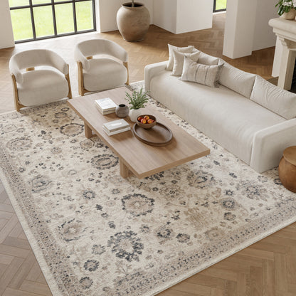 Bright living room with cream fabric sofa, two matching armchairs, and natural wood coffee table on a beige patterned rug.