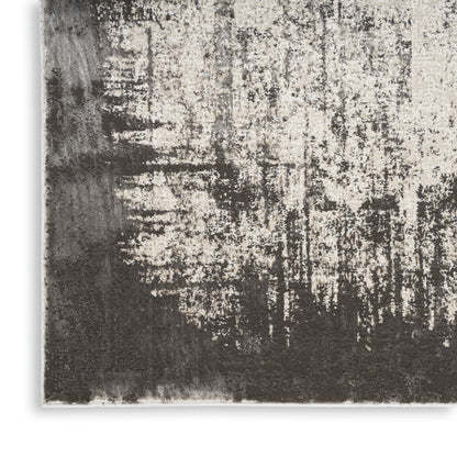 Neutral abstract area rug in beige & charcoal with distressed texture and modern pattern.