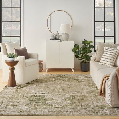 Cream sofa and armchair, olive-green patterned vintage rug (7' x 9'), geometric cream cabinet with round mirror, lamp and plant.