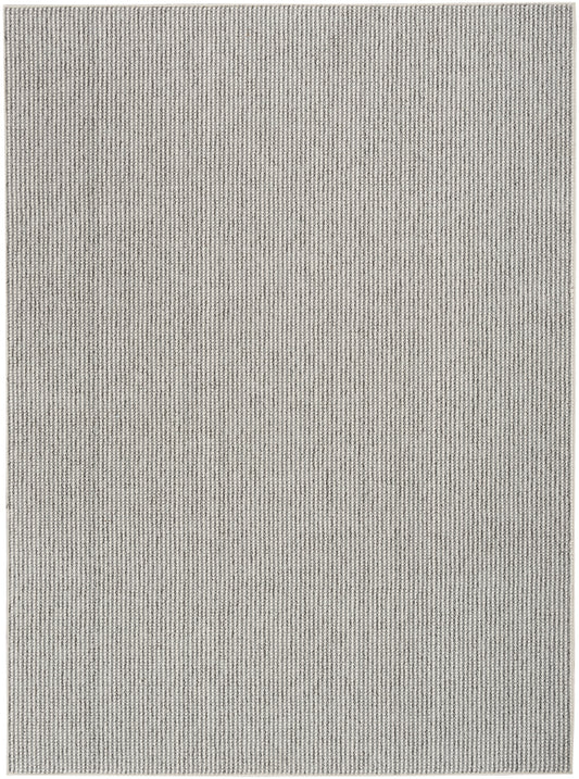 Light gray flat-weave rug with subtle vertical stripe texture; rectangular, farmhouse decor.