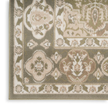 Close-up of a Persian-style rug in olive, beige and cream with floral medallions and a decorative border.