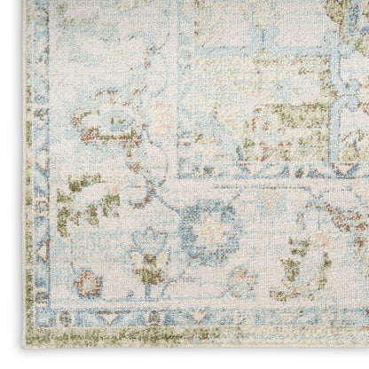 Blue and ivory distressed floral area rug with vintage border, oriental-style.