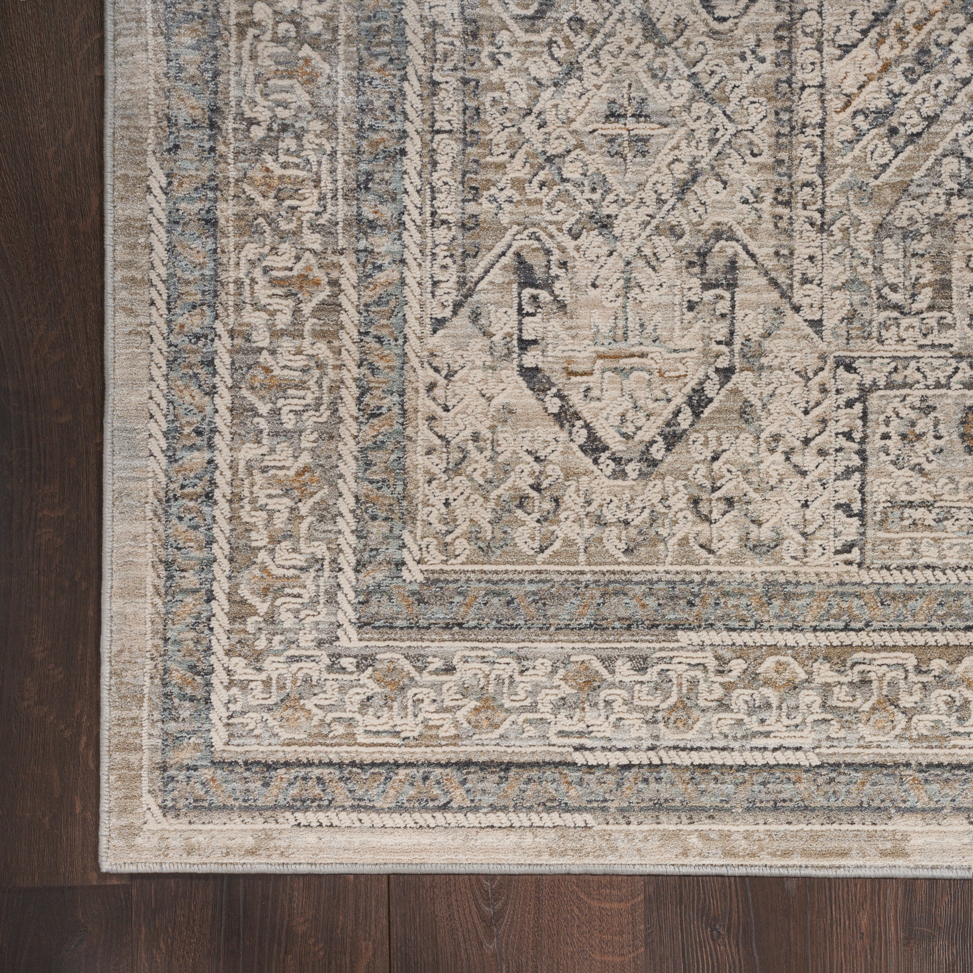 Rectangular vintage-style runner rug, 10' long, in beige, ivory, gray & blue hues with a distressed geometric pattern on dark wood floor.
