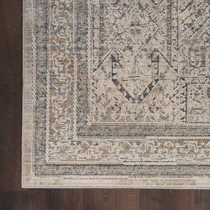 Rectangular vintage-style runner rug, 10' long, in beige, ivory, gray & blue hues with a distressed geometric pattern on dark wood floor.
