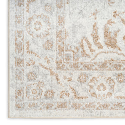 Rectangular beige and ivory area rug with vintage floral medallion pattern and distressed finish.