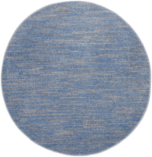 Round blue heathered rug with beige flecks; soft woven texture for living spaces.