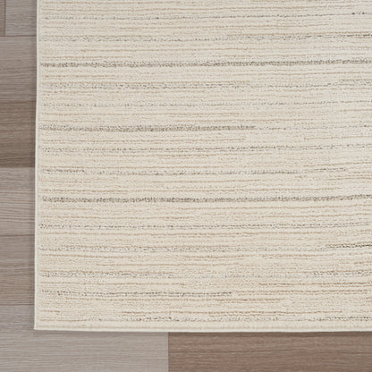 Beige textured rectangular rug with subtle horizontal stripes on light wood floor.