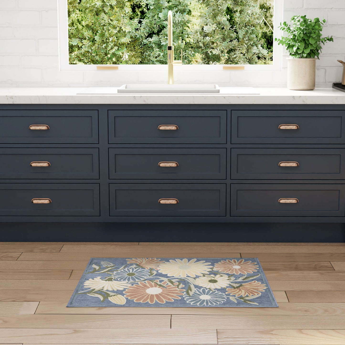 Navy blue floral outdoor rug on wood floor, 3' x 4'.