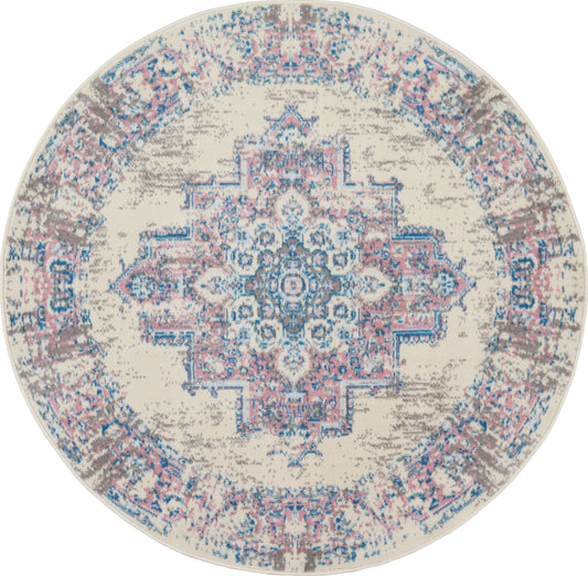 Round vintage distressed area rug with a blue and pink central medallion on cream background.