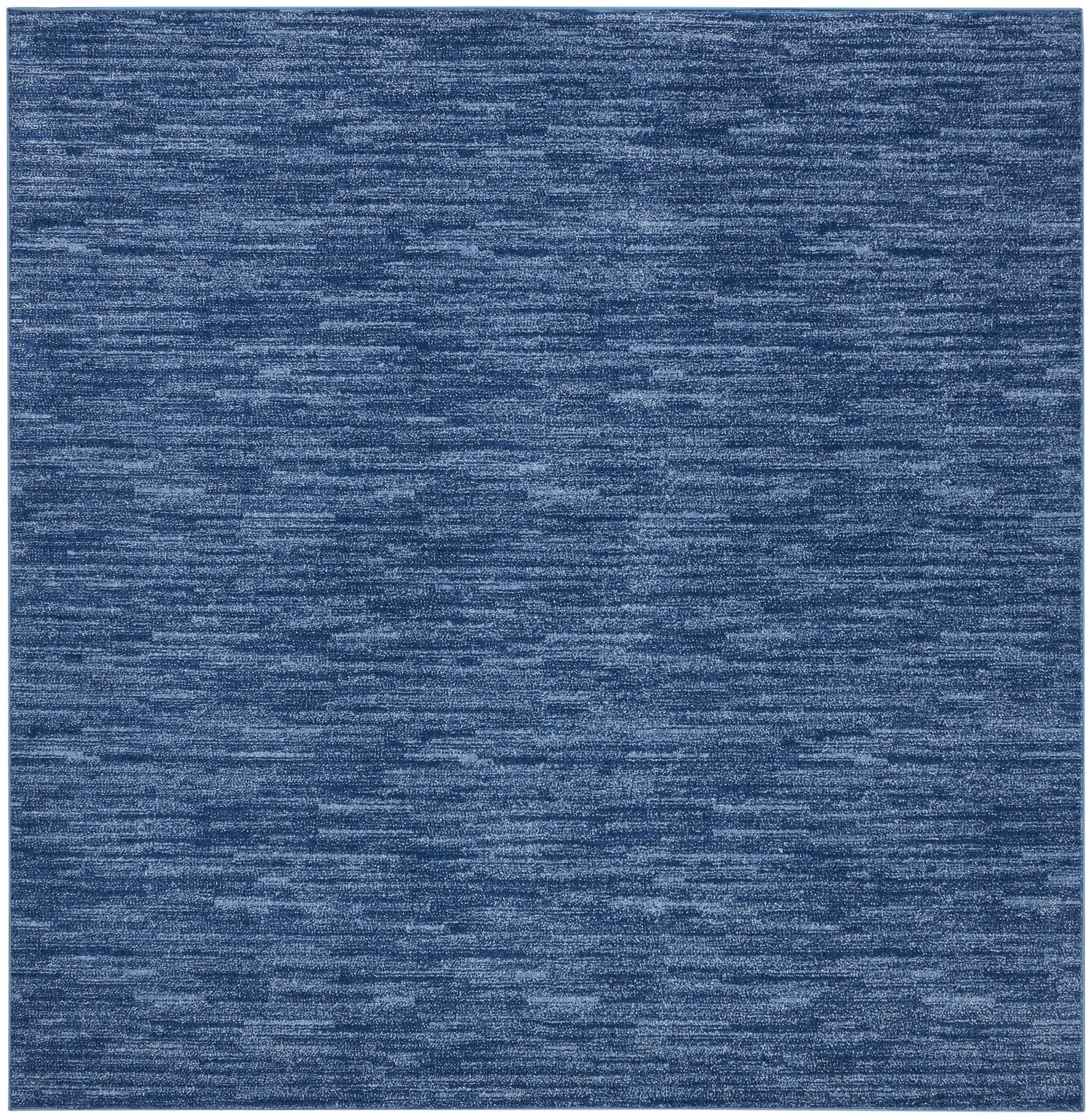 Blue heathered outdoor rug with marled texture and soft micro-pile; square denim shade.