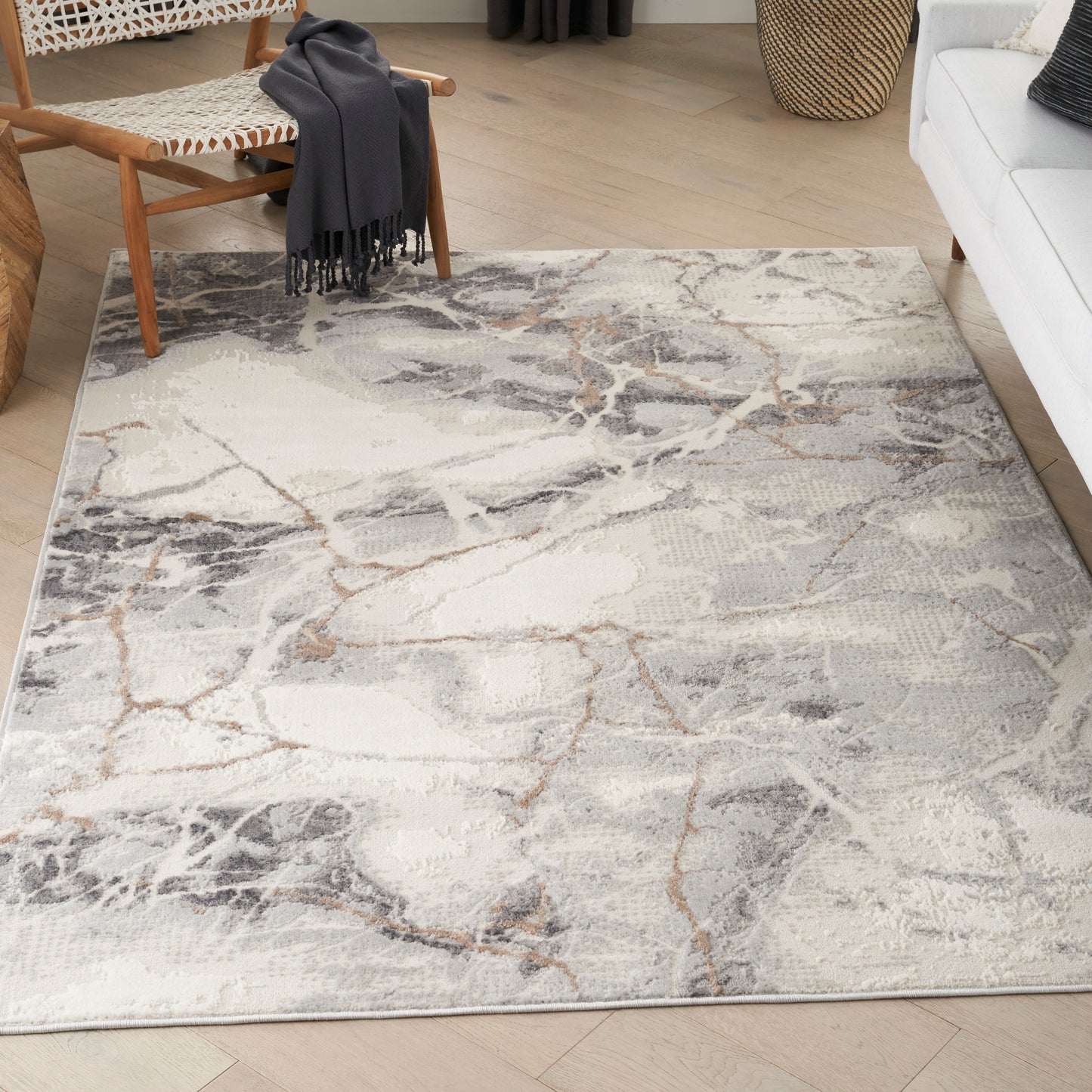 Rectangular light gray marble-pattern area rug with beige and charcoal veining in a contemporary living room