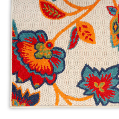Beige woven rug corner with vivid orange, teal, red and blue floral motif; textured tapestry style.