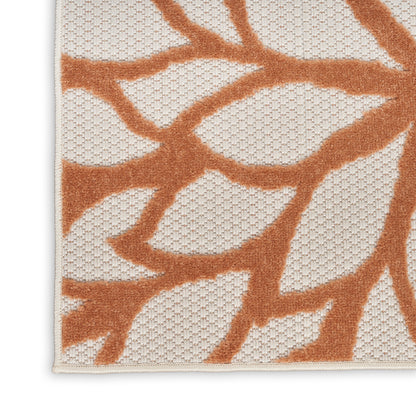 Rectangular cream rug with orange botanical branch motif, textured weave, modern decorative style for living rooms