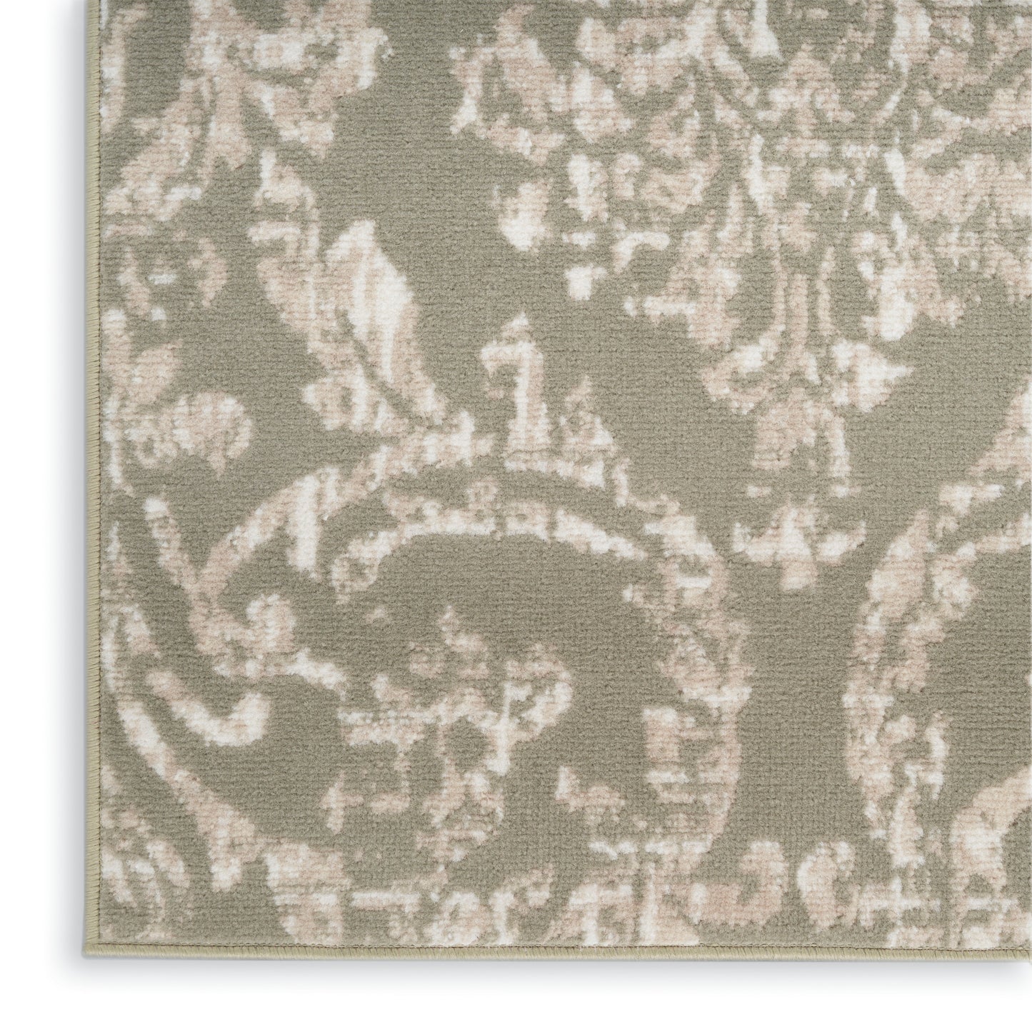 Beige damask patterned fabric with taupe floral scrolls; close-up upholstery weave.