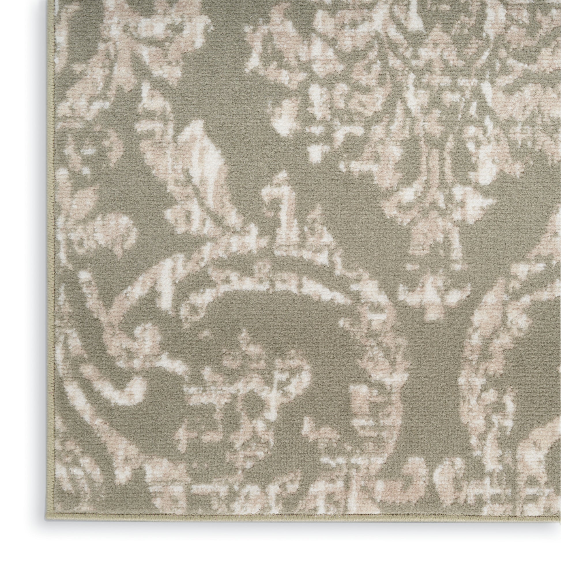 Beige damask patterned fabric with taupe floral scrolls; close-up upholstery weave.