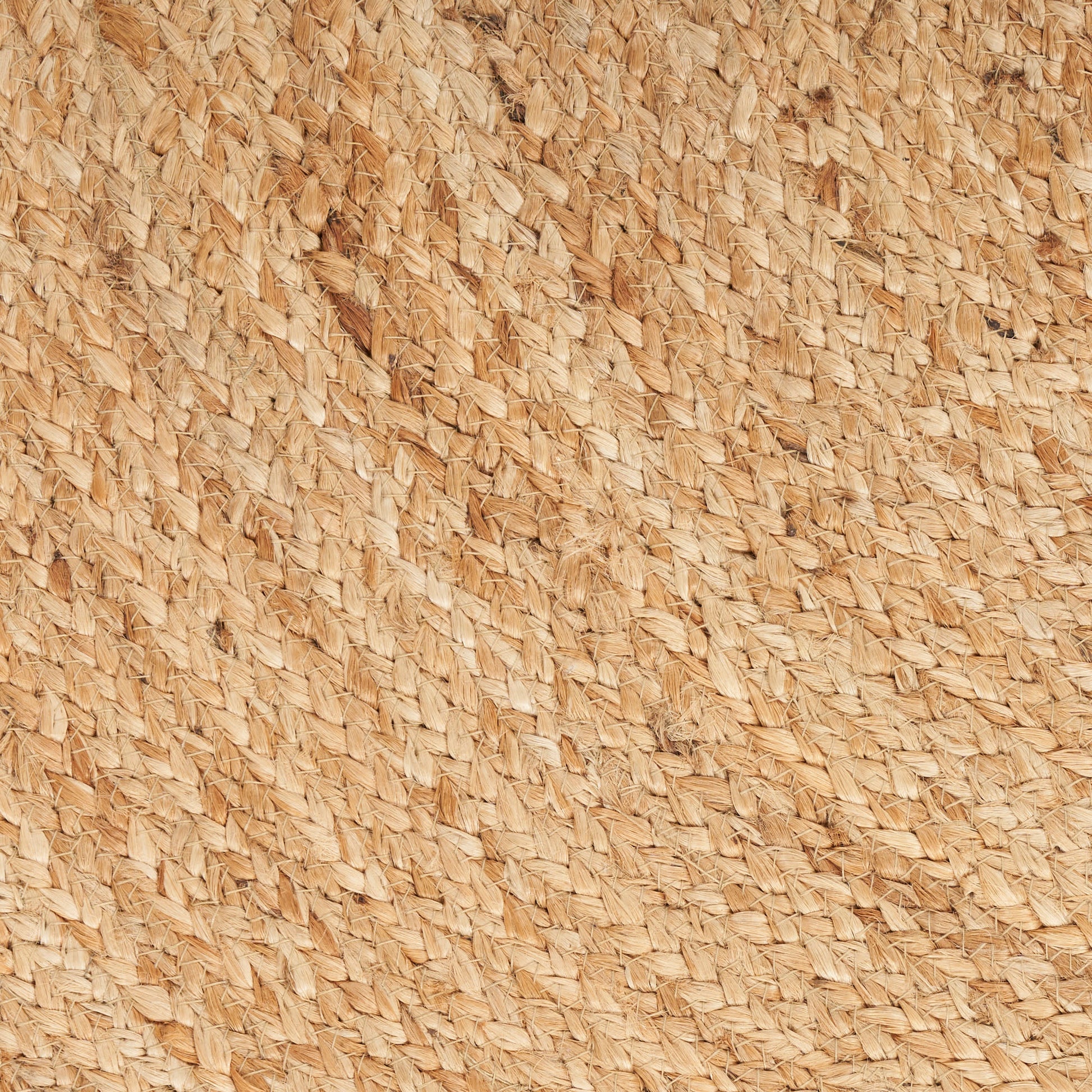 Close-up of natural straw/raffia weave in warm beige with a diagonal textured pattern, rustic round rug.