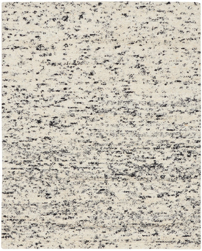 Beige rug with charcoal speckled abstract pattern; low-pile rectangular area rug for living room.