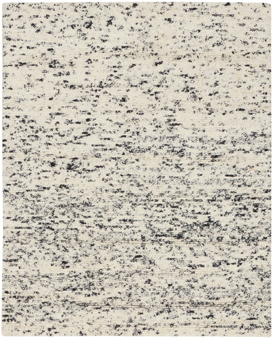 Beige rug with charcoal speckled abstract pattern; low-pile rectangular area rug for living room.