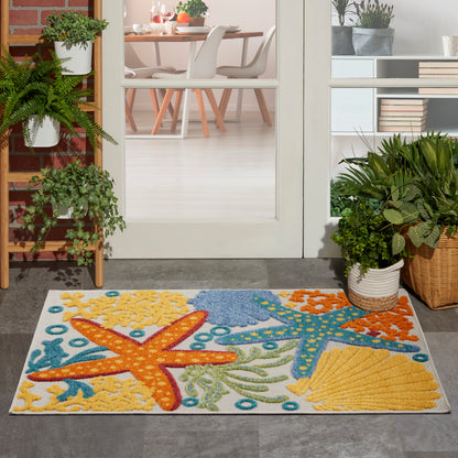 Coastal rug with colorful starfish and sea life in yellow, orange & blue on a white background.