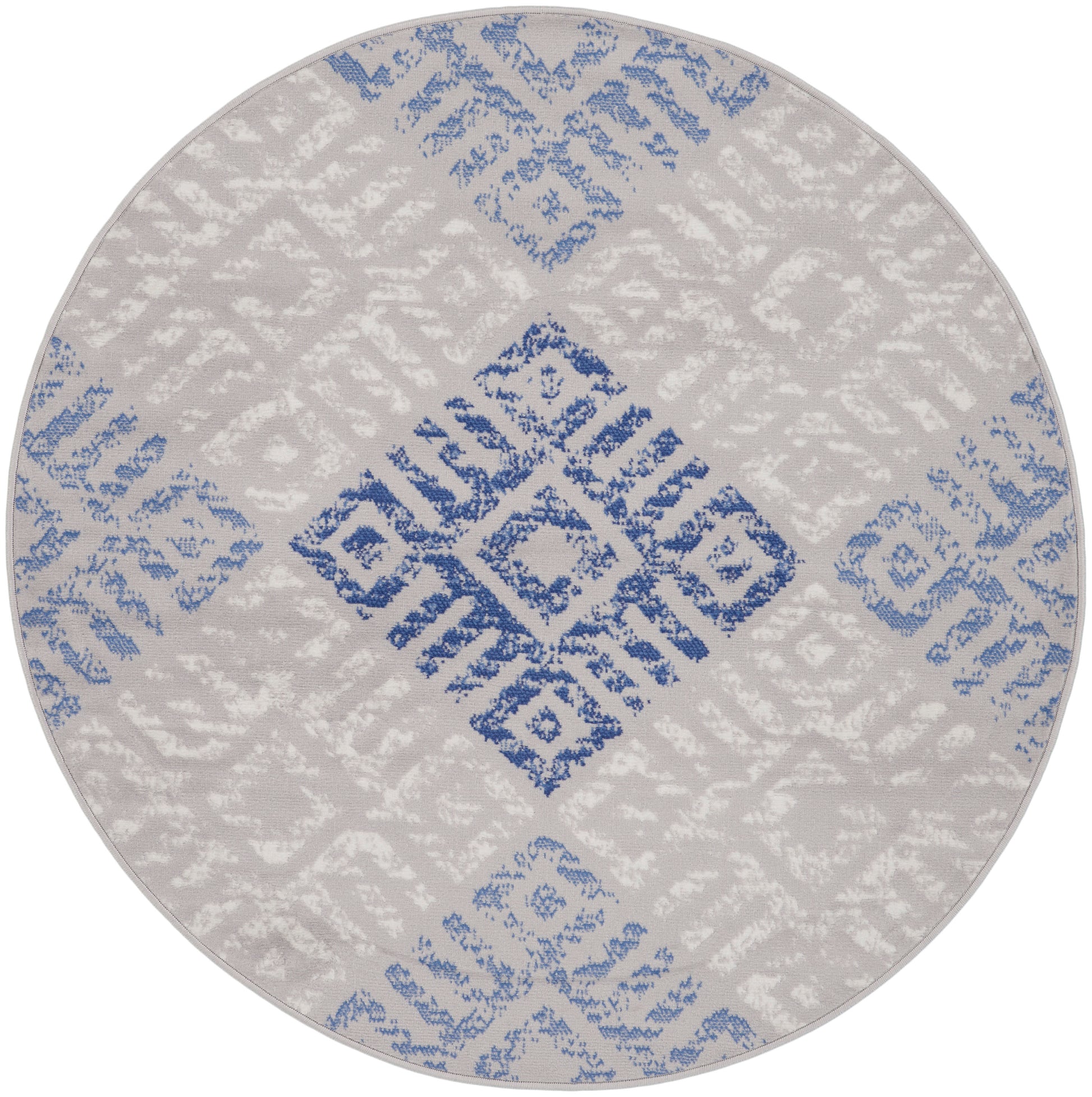 Round rug with light grey base and blue geometric diamond lattice pattern; soft woven textile.