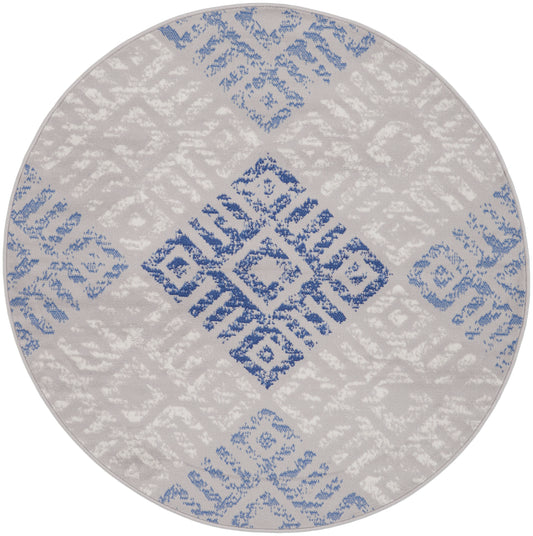 Round rug with light grey base and blue geometric diamond lattice pattern; soft woven textile.