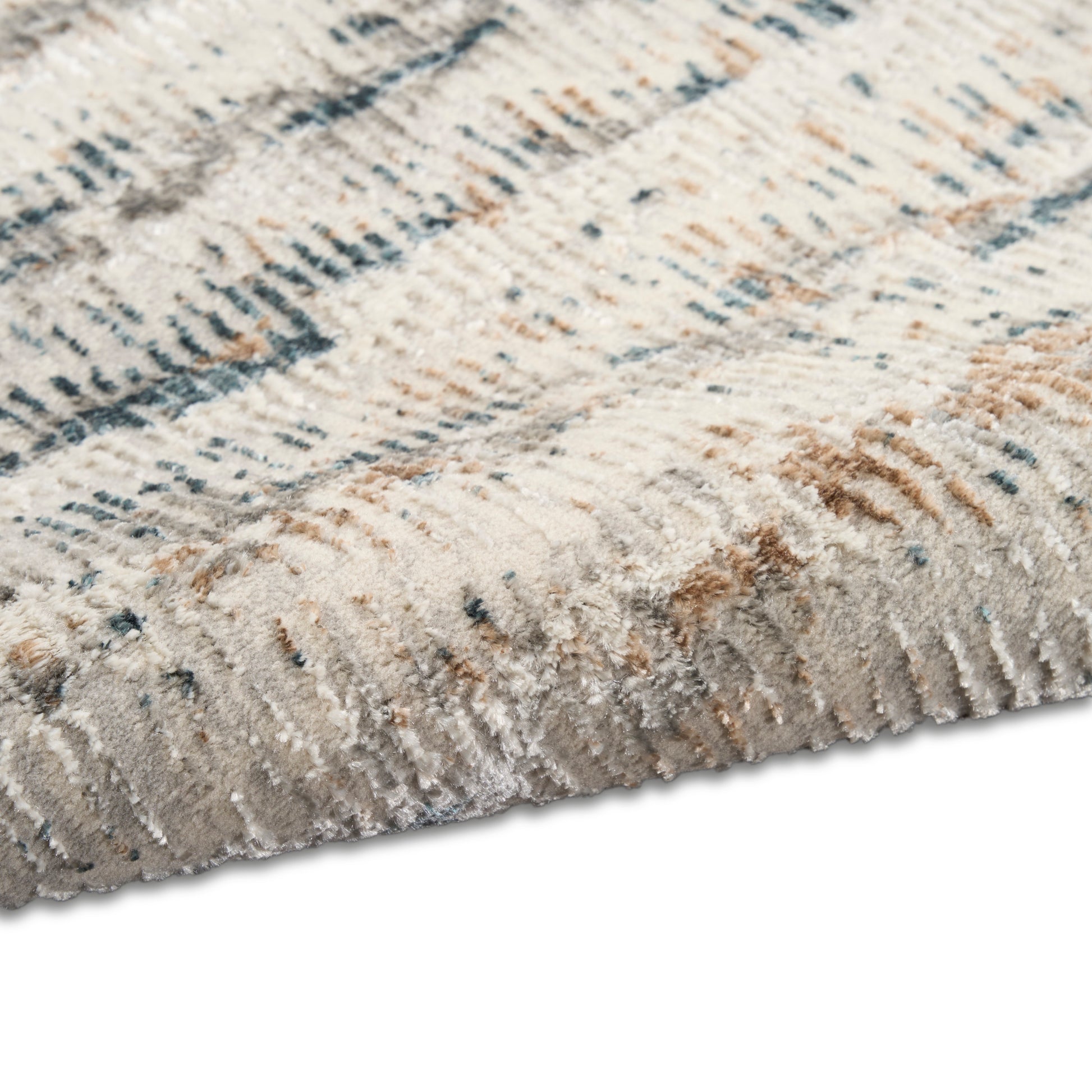 Cream and taupe plush area rug with blue-gray abstract linear pattern; soft high-pile, modern decor.