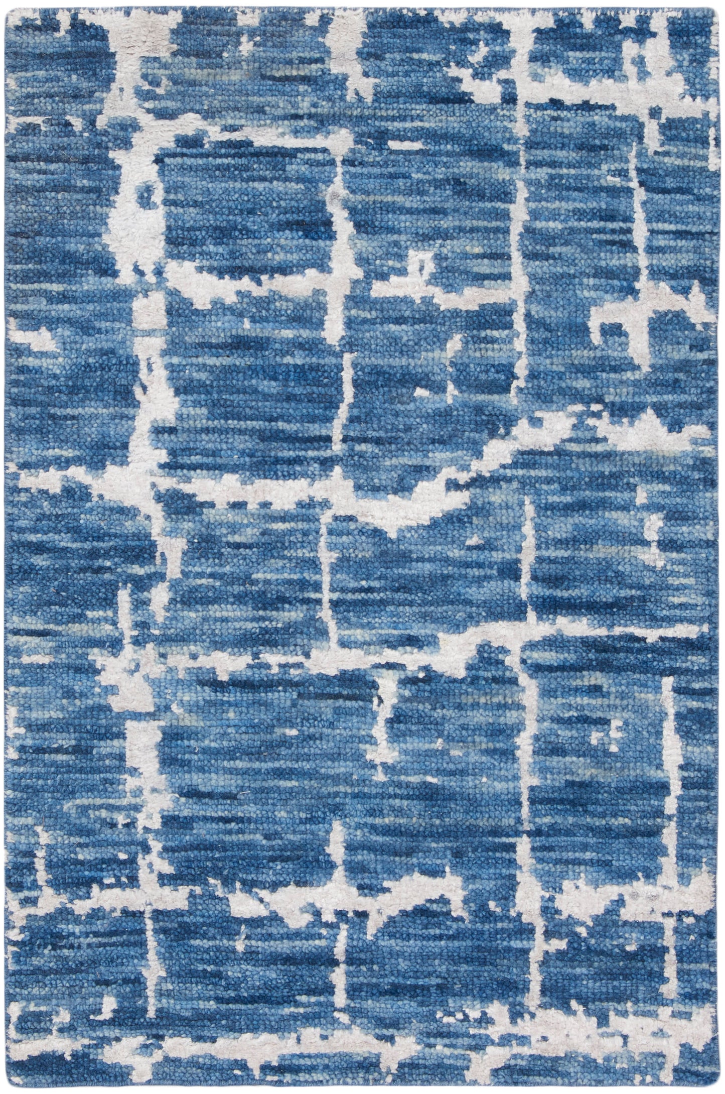 Rectangular blue area rug with white abstract grid pattern and distressed texture; modern, versatile for living rooms.