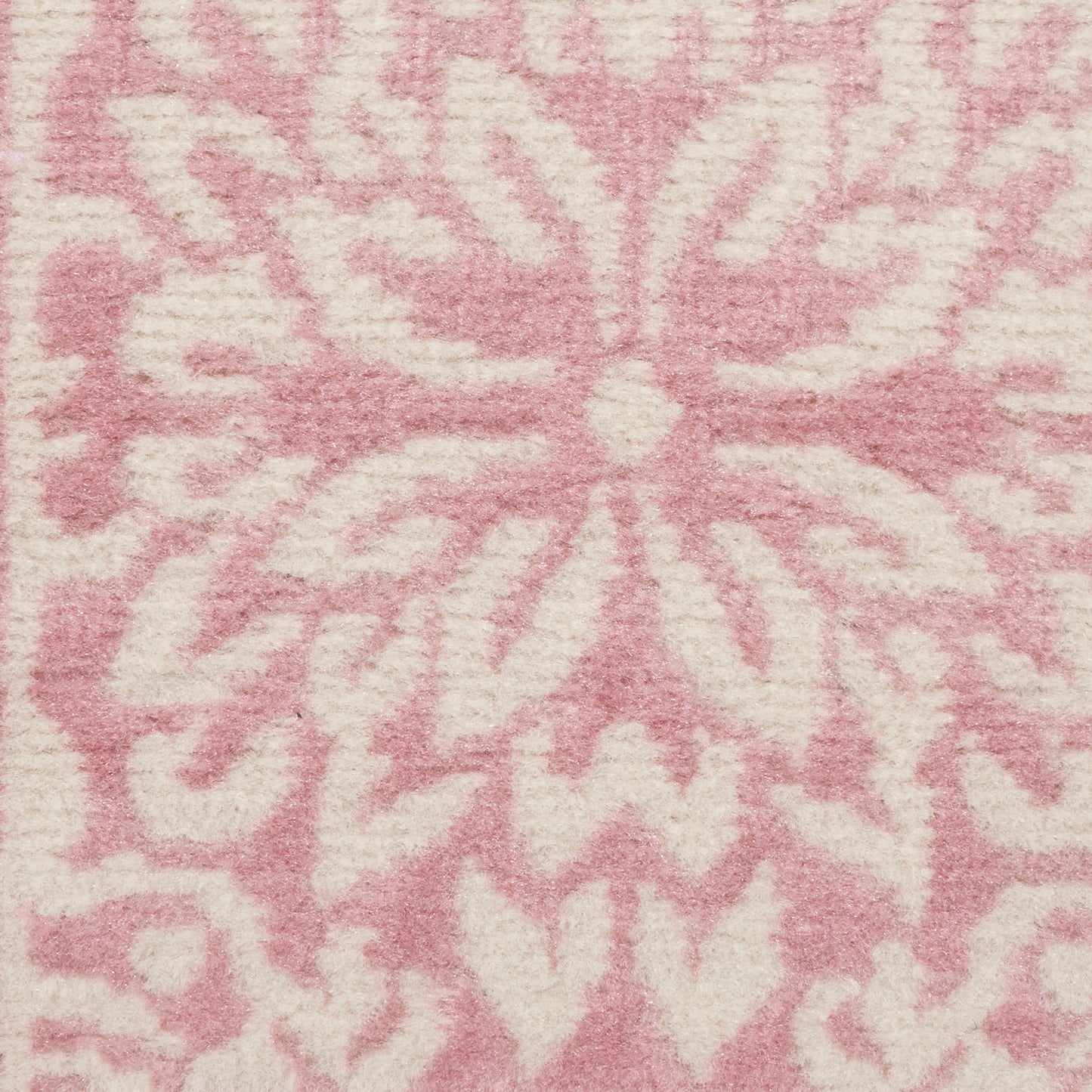 Soft pink rug with large cream floral/starburst pattern; plush, cozy indoor decor rug, 2' x 4'.