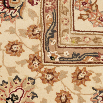 Close-up of an oriental rug: cream field, brown & gold floral border, with intricate medallion-style pattern.