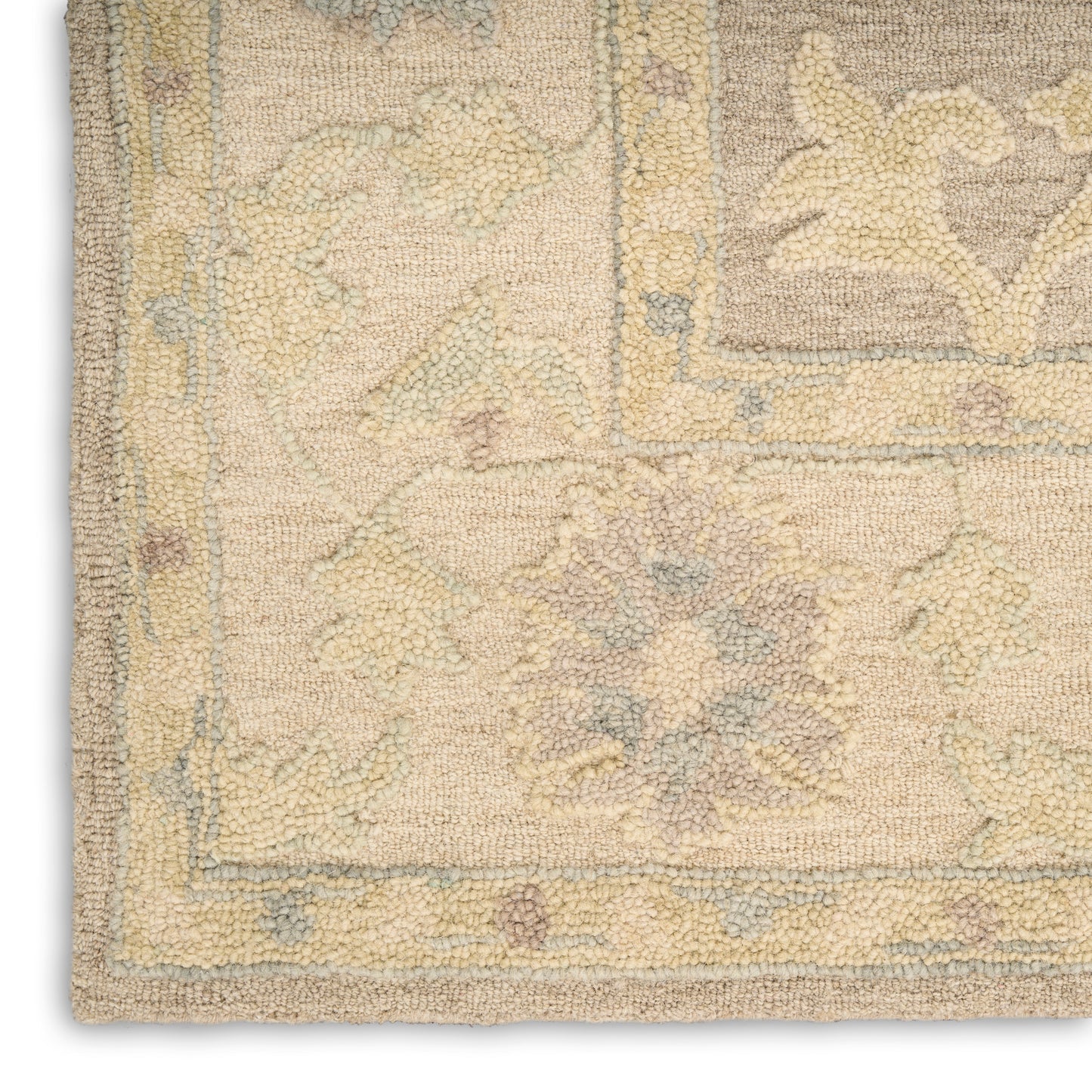 Beige vintage-style floral area rug with pale blue, yellow, and pink accents; intricate border and central medallion.