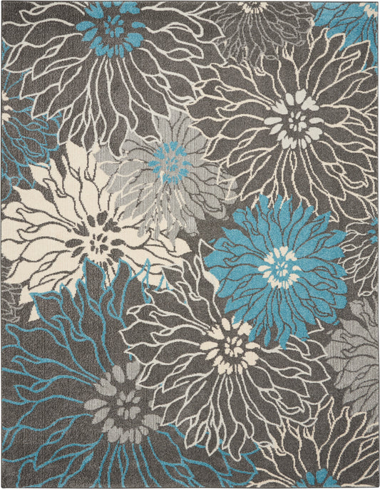Woven area rug with oversized teal, white and cream flowers on gray background.