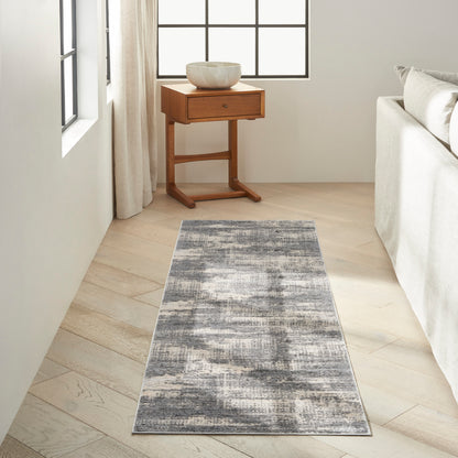 Gray abstract runner rug on a bright living room floor, 7' long.
