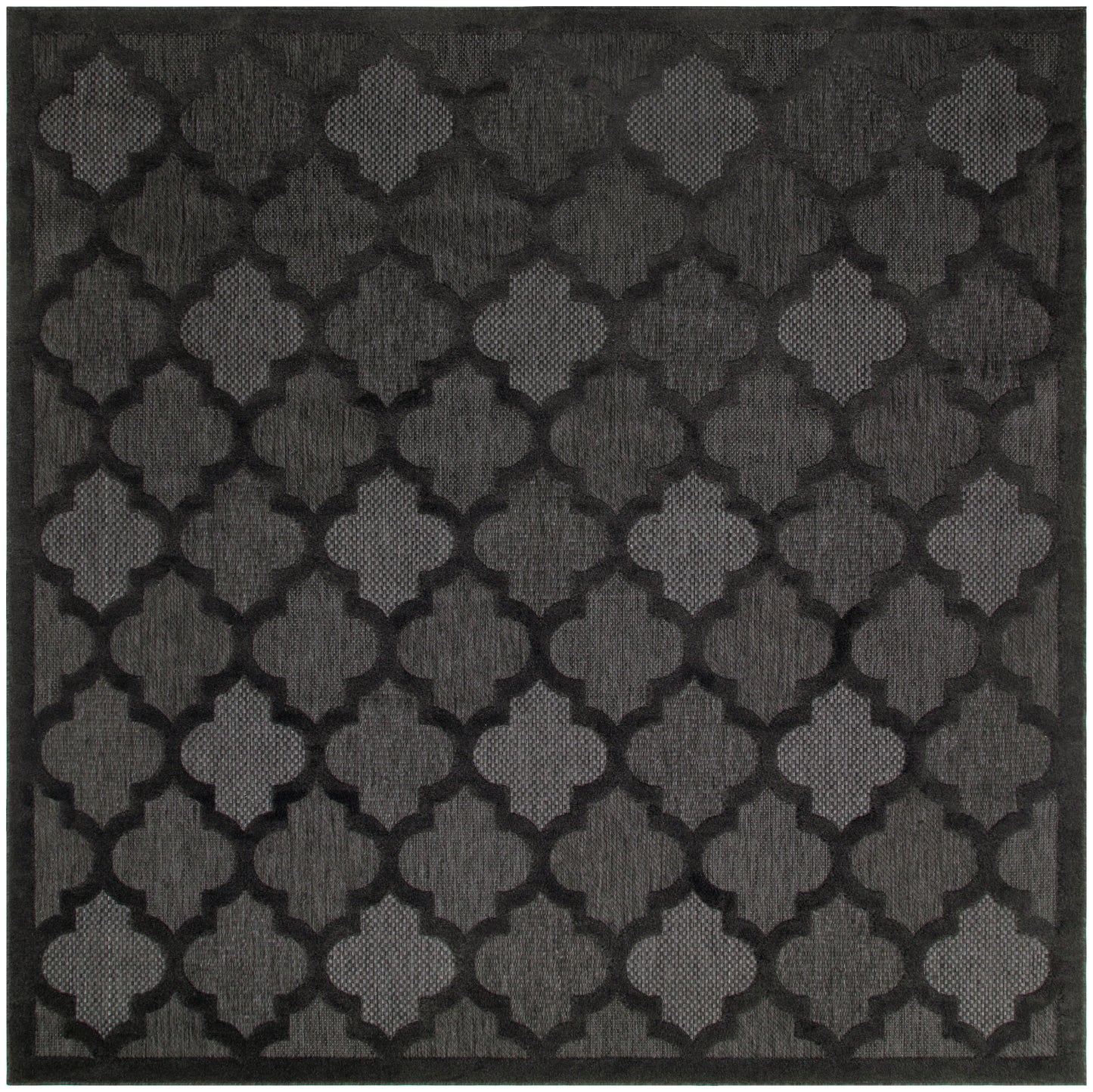 Charcoal-black square rug with a repeating quatrefoil lattice pattern and textured weave.