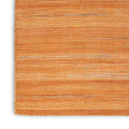 Close-up of orange woven rug with textured fibers and subtle light horizontal stripes.