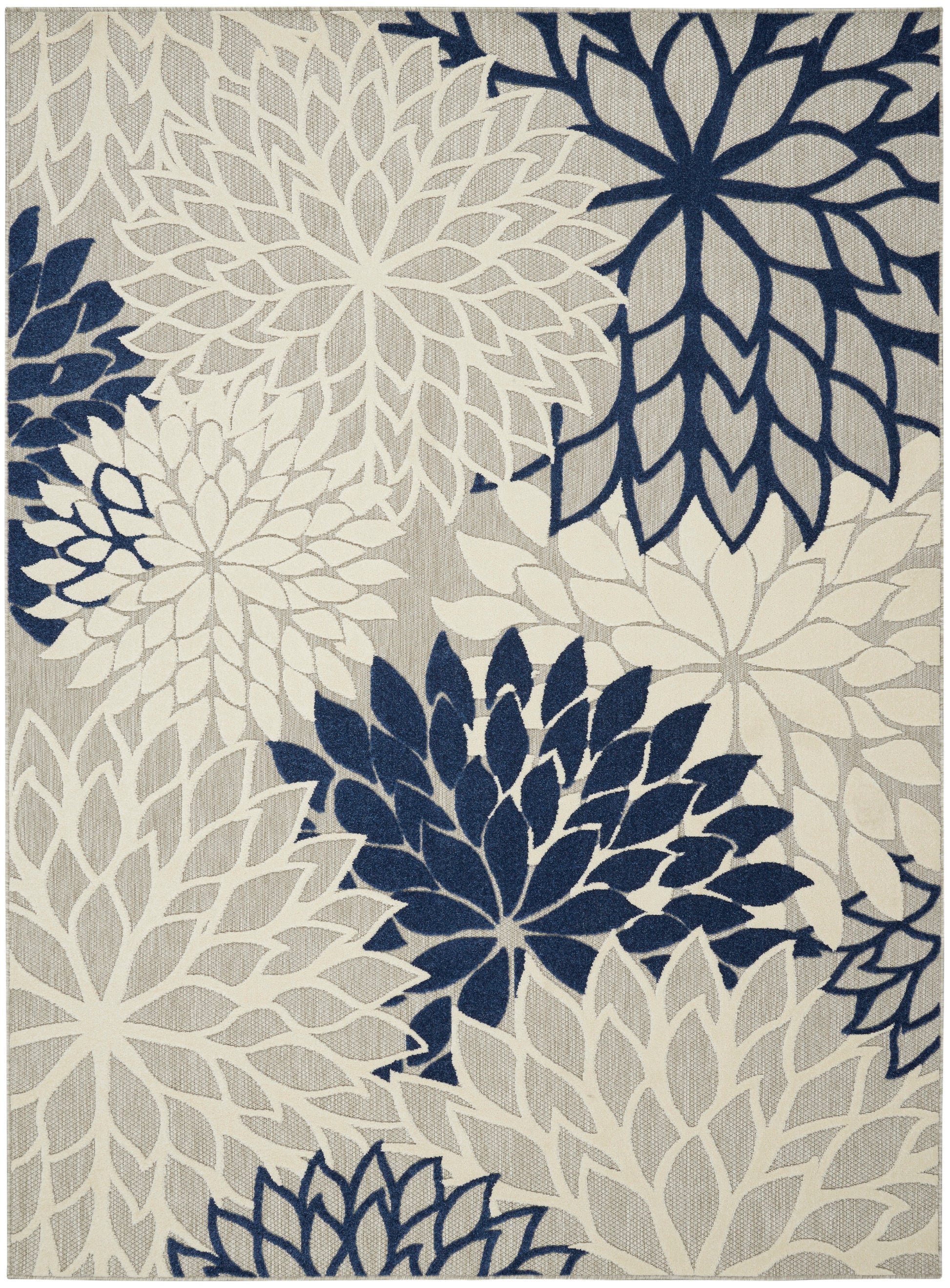 Navy and cream floral pattern rug with large petal medallions on beige background; modern woven area rug.
