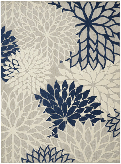Navy and cream floral pattern rug with large petal medallions on beige background; modern woven area rug.