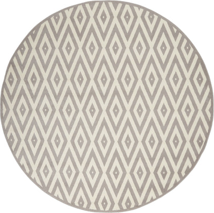 Round rug with a gray and ivory diamond lattice pattern; mid-century modern geometric style.