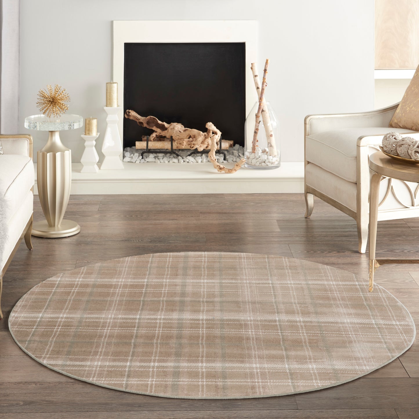 Round beige plaid area rug for a neutral living room with cream furniture and a fireplace.