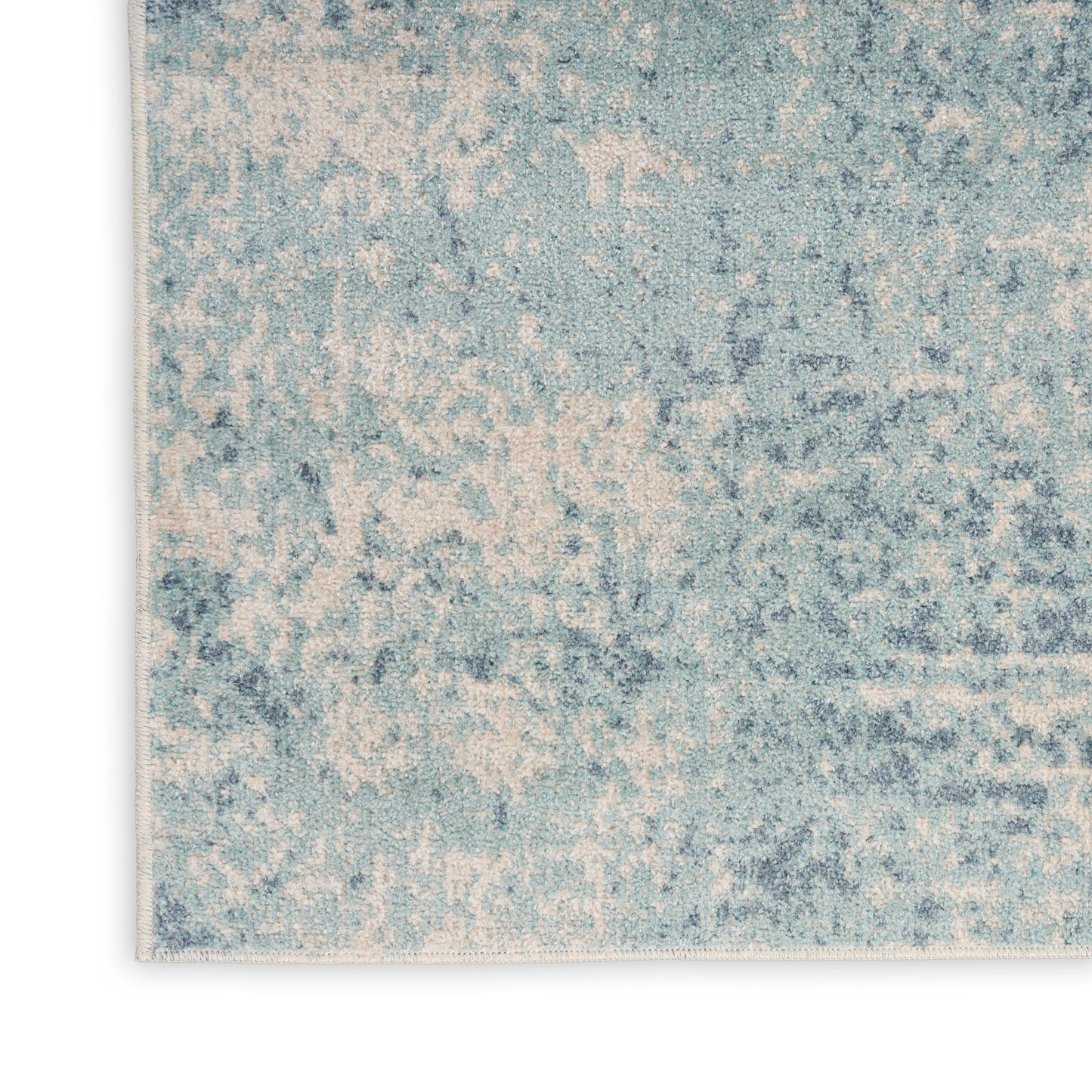 Rectangular blue and ivory distressed rug with a mottled pattern and soft pile for casual modern decor.
