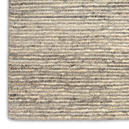 Close-up of gray and beige striped textured rug with a soft loop pile.