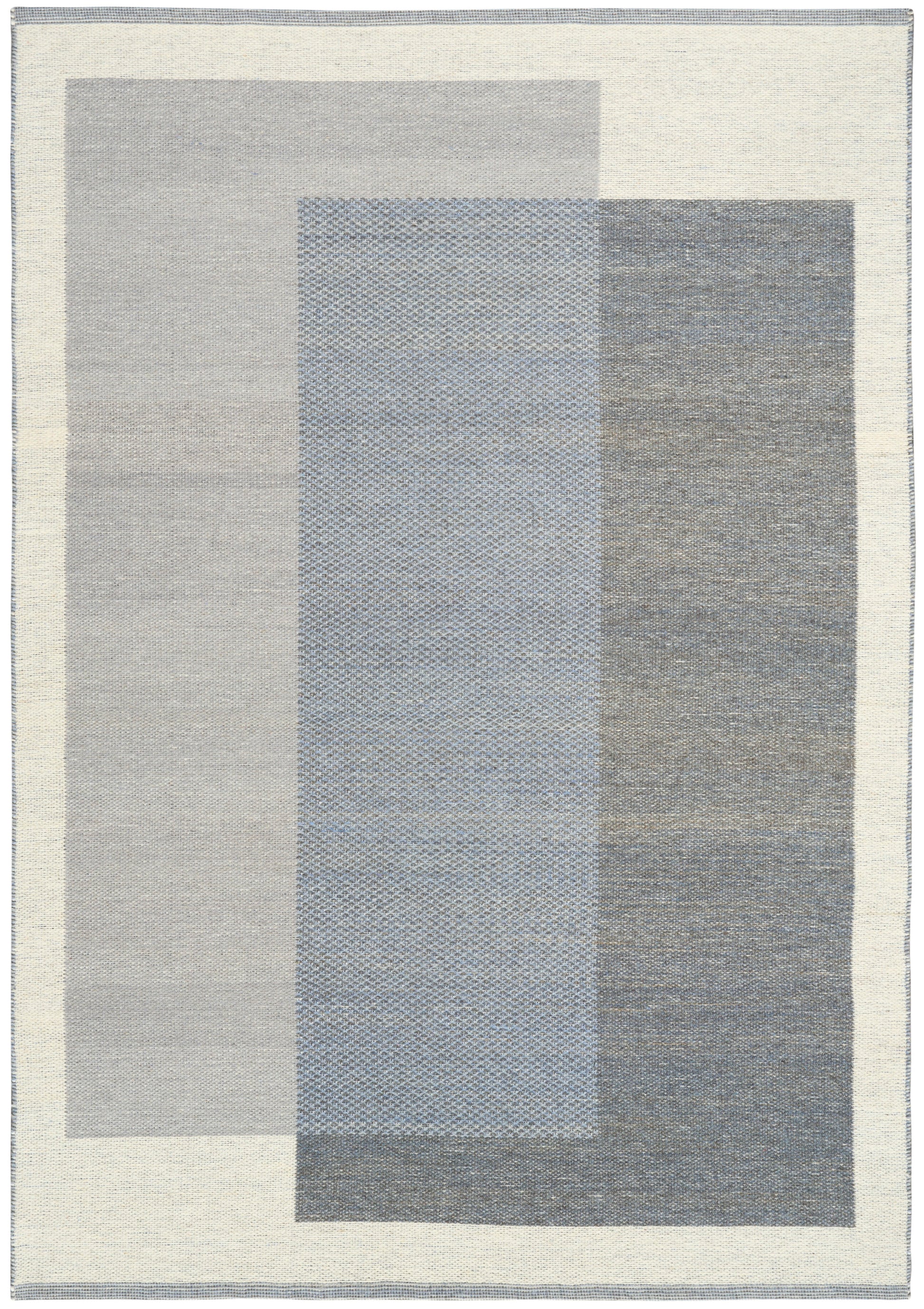 Modern geometric rug featuring overlapping gray and blue rectangles in cool tones with a cream border.