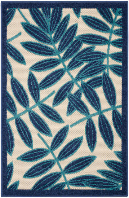 Rectangular rug with teal and navy blue botanical leaves on cream background & deep navy border.