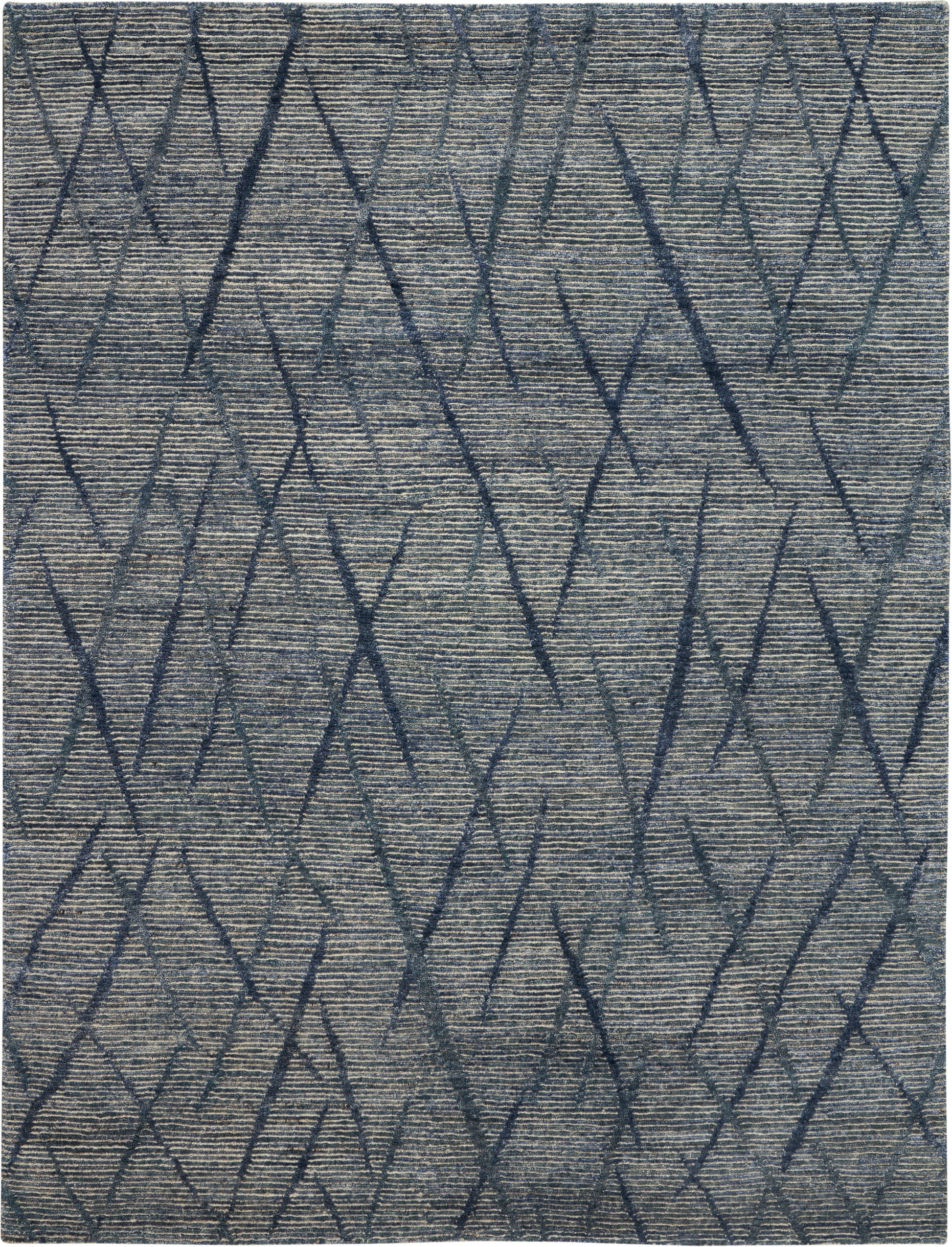 Blue-gray rug with dark navy geometric diamonds on a textured woven surface.
