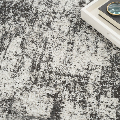 Abstract distressed area rug in black, gray and ivory with a plush, modern look.