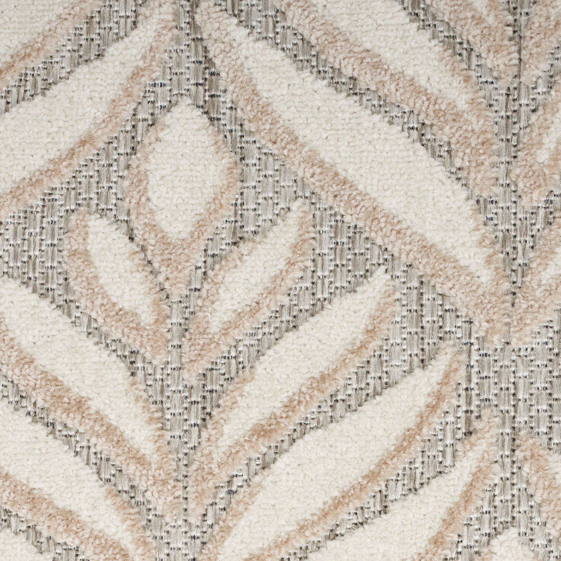 Soft tufted round shag rug with cream and beige chevron leaf pattern on gray ground; plush, modern boho-style decor.