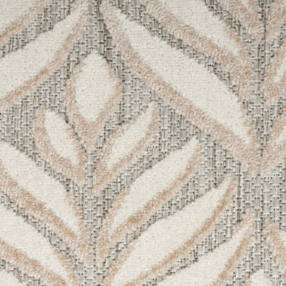 Soft tufted round shag rug with cream and beige chevron leaf pattern on gray ground; plush, modern boho-style decor.