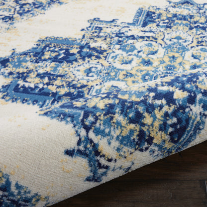 Blue and cream distressed oriental rug with floral motifs, partially rolled on a dark wood floor.